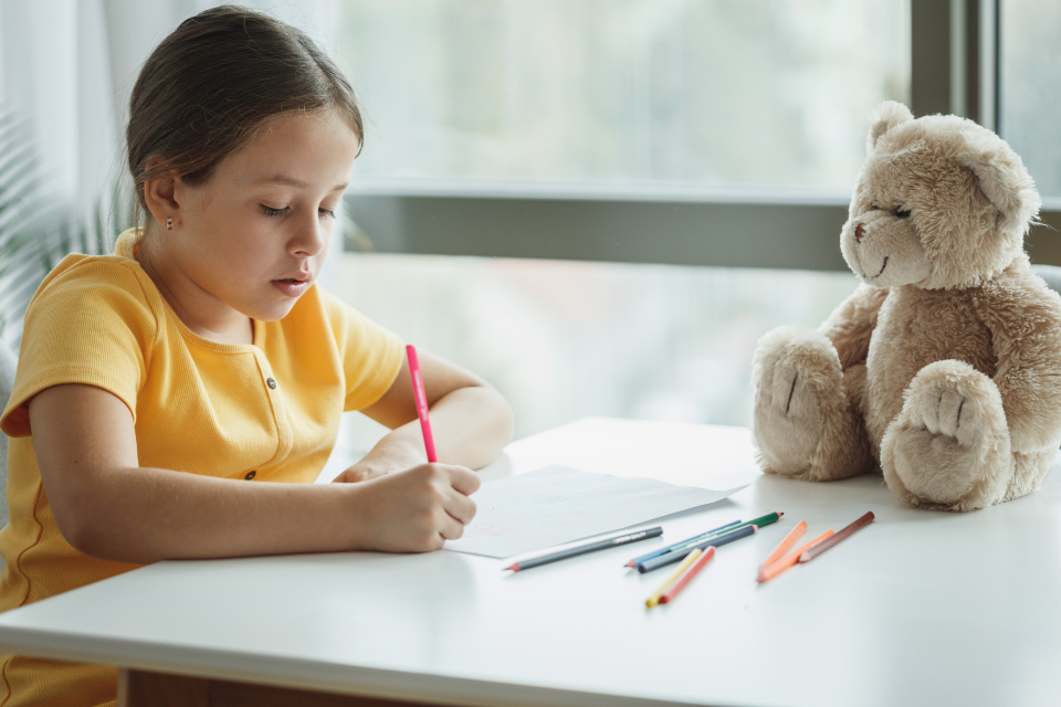 A young student writing at her desk